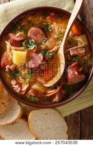 Czech Traditional Soup Zelnacka Of Sauerkraut With Sausages Close-up In A Bowl. Vertical Top View