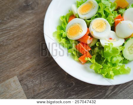 Close Up Healthy Bowl Of Homemade Salad With Fresh Vegetables, Crab Stick, Eggs