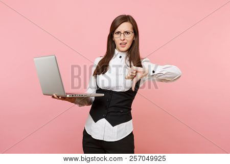 Young Dissatisfied Business Woman In Suit, Glasses Working In Laptop Showing Thumb Down Isolated On 