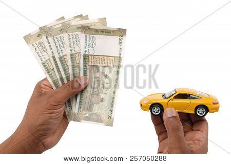 Indian Currency Notes And Toy Car In The Hands Bank Loan Concept