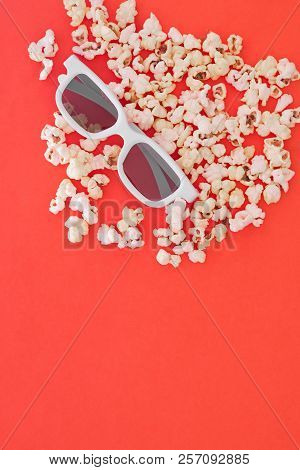 Popcorn And White 3d Glasses On A Bright Red Background, Top View. Background. Pattern. Flat Lay. Co