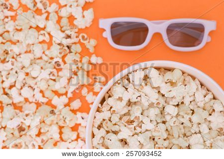 White 3d Glasses, Paper Cup And Fresh Cheesy Popcorn On A Orange Background, Top View, Copyspace. Ci