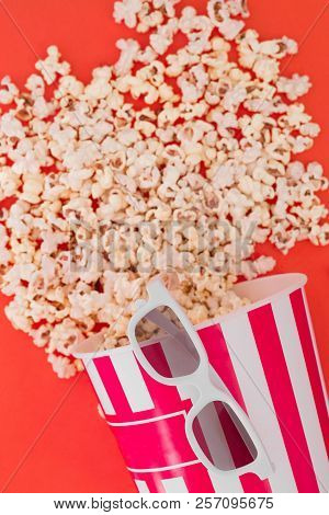 Popcorn In A Paper Bowl And 3d Glasses For Watching A Film On A Red Background, Top View. Flat Lay. 