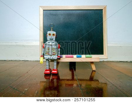 robot and a  blacboard on a wooden floor  with reflection 
