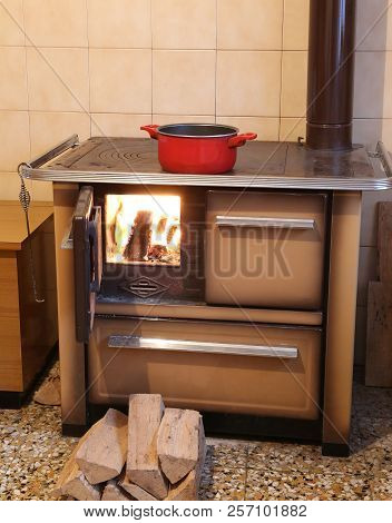 Old Cast-iron Wood Stove In The Kitchen Of The Small Chalet In The Mountains