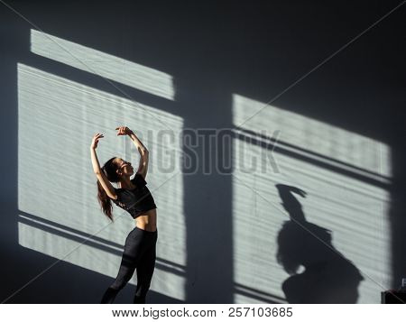 A young girl is engaged in jazz modern dance in the hall