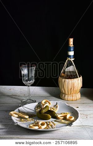 Bodegon With Plate Of Anchovies In Vinegar, Pickles And Wine