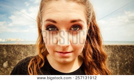 Close Up Of Funny Young Teenage Woman. Bizzare Fish Eye Angle. Outdoor Shot.