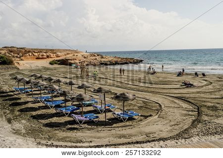 Torrevieja, Spain - Sept. 07 2018 :   Beach Loving Holiday Makers At Mosca Cala Playa.