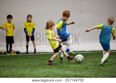 MOSCOW, RUSSIA - JAN 27, 2018: Players of children teams during children sport clubs cup soccer game at indoor sports ground of Krasnaya Presnya stadium.