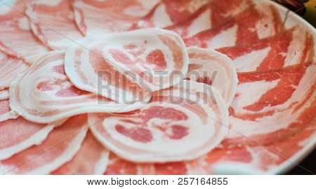 Thin Pork Slides With Fat Lines Stacked On Plate In Shabu Restuarant