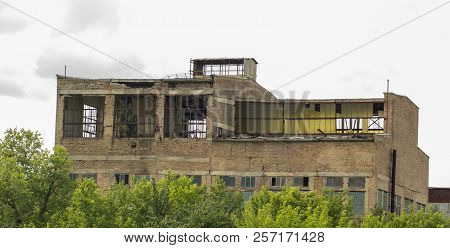 Broken Windows In An Old Building Of An Abandoned Factory.