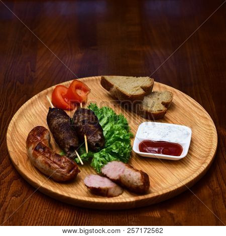 Fresh Grilled Meat. Grilled Shish Kebabs And Sausages On Wooden Cutting Board. Grill Bar. The Grill 