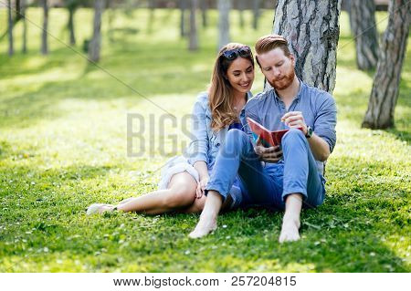 Lovely University Students Studying Outdoors In Park