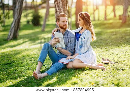 Lovely University Students Studying Outdoors In Park