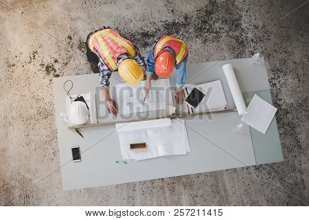 Top View Of Architects And Engineers To Help Create A Blueprint To Build A Modern Building Equipped