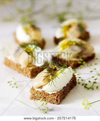 Tradition Danish Open Sandwich Smorrebrod With Herring, Egg, Mustard And Dill. Dark Bread Sandwich.