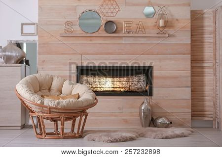 Cozy Living Room Interior With Comfortable Papasan Chair And Decorative Fireplace