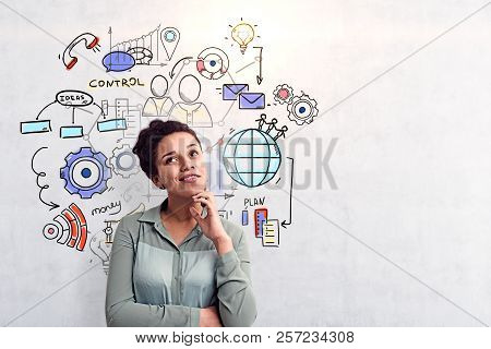 Smling And Thoughful African American Girl Sitting Near Concrete Wall With Colorful Management And B