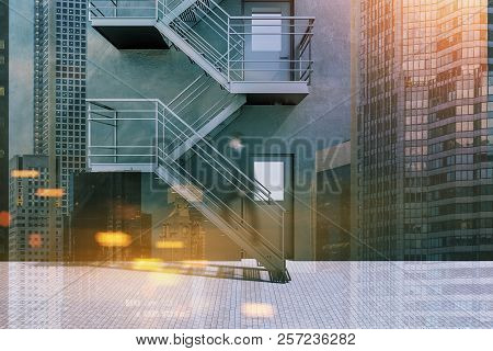 Modern Building Exterior With Dark Gray Walls, Grey Doors And Emergency Exit Stairs With A Businessm