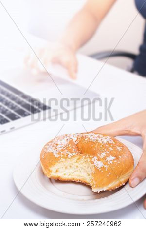Women Are Eating Junk Food And Sweet Bread While Working.