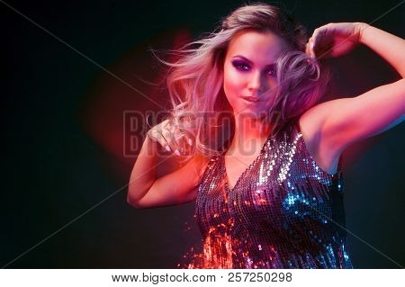 Bright And Stylish Young Woman Dancing In Club, Color Light, Motion Effects. Black Background, Long 