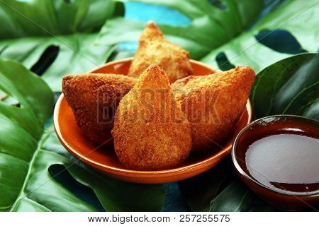 Coxinha Street Food. Brazilian Chicken Coxinha Over Rustic Background.
