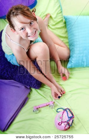 Young girl painting toenails