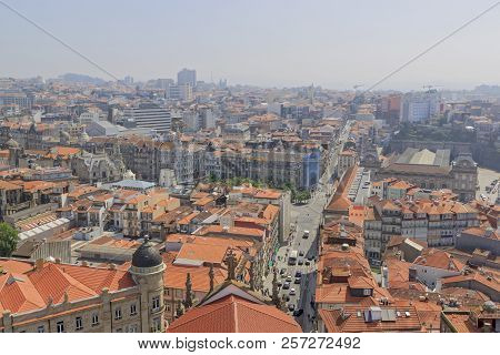 Scenic View Of Porto, Portugal From The Window Of The Tower. Orange Roofs Of The Houses. Popular Tou