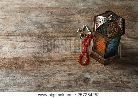 Muslim Lamp And Misbaha On Wooden Background. Fanous As Ramadan Symbol