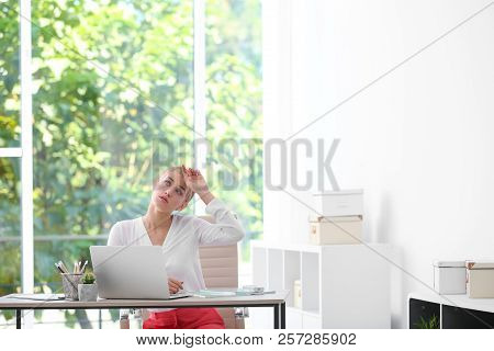 Young Woman Suffering From Heat In Office. Air Conditioner Malfunction