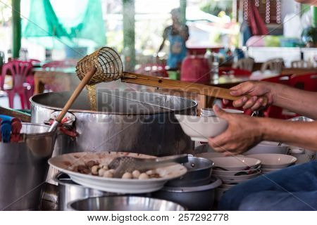 Chef Cooking A Noodle Soup At Street Food Market