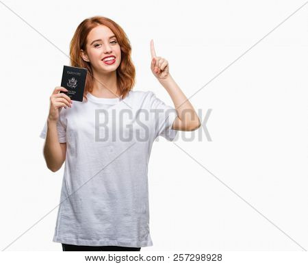 Young beautiful woman holding passport of united states of america over isolated background surprised with an idea or question pointing finger with happy face, number one