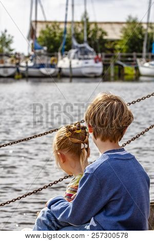 Brother And Sister Enjoying Their Vacation In The Harbour