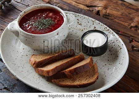 Traditional Ukrainian Russian Borscht With White Beans On The Bowl. Plate Of Red Beet Root Soup Bors