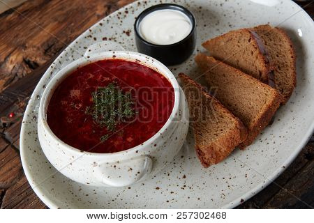 Traditional Ukrainian Russian Borscht With White Beans On The Bowl. Plate Of Red Beet Root Soup Bors