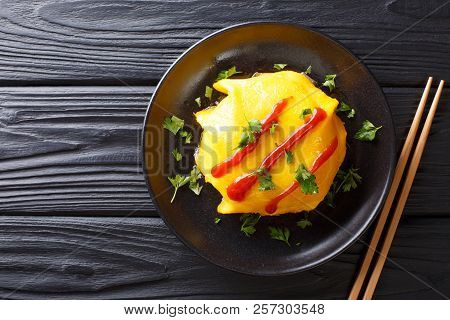 Delicious Omurice Omelette Stuffed With Rice, Chicken And Vegetables Served On A Plate. Horizontal T