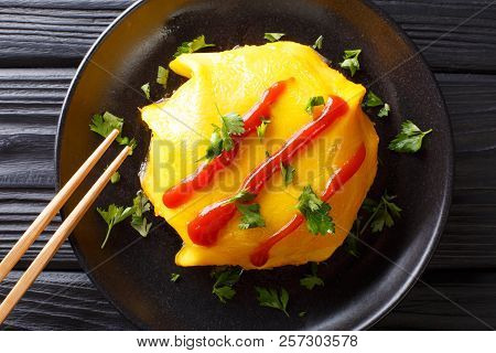 Recipe For Japanese Omelette With Rice, Chicken, Vegetables And Tomato Sauce On A Plate On A Wooden