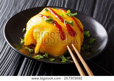 Recipe For Japanese Omelette With Rice, Chicken, Vegetables And Tomato Sauce On A Plate On A Wooden
