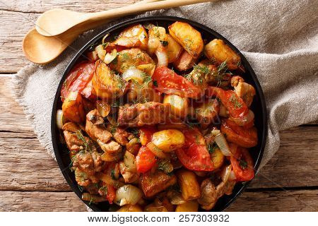 Ojahuri Fried Meat With Potatoes, Tomatoes, Herbs And Spices Close-up On A Frying Pan. Horizontal To