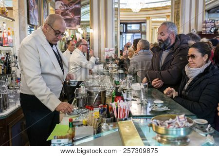 Naples, Italy - December 3, 2017: Unidentified people visiting famous italian cafe Gambrinus. It is a historical coffee shop in Naples