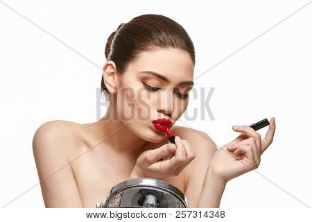 Girl Applying Red Lipstick Isolated On White