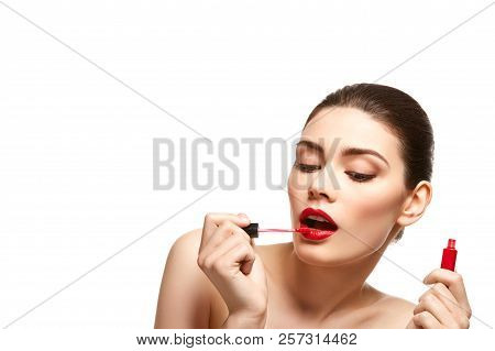 Girl Applying Red Lipstick Isolated On White