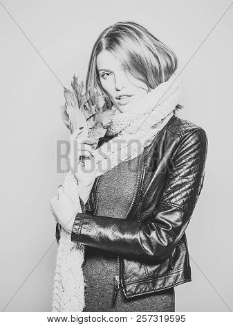 Beauty And Fashion. Woman With Autumn Leaves In Leather Jacket. Girl With Orange Leaves On Blue Back