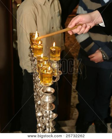 Rabi lights a candle in the Jewish holiday of Hanukkah