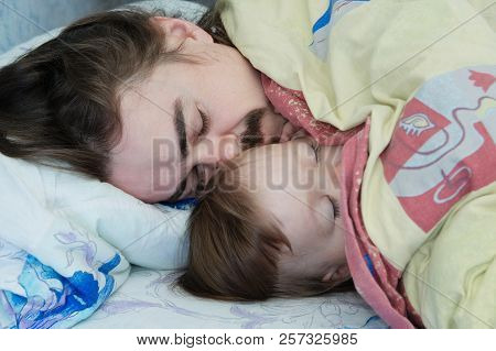 Little Baby Girl Sleeping With Dad In The Morning. Happy Parent. Father Lying On Bed. Happy Family.