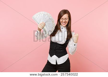 Young Happy Business Woman In Glasses Holding Bundle Lots Of Dollars, Cash Money Doing Winner Gestur