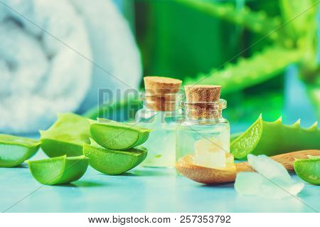 Aloe Vera Extract In A Small Bottle And Pieces On The Table. Selective Focus.