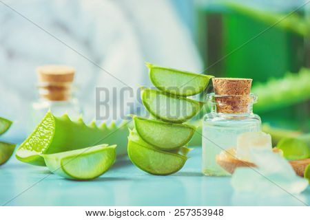 Aloe Vera Extract In A Small Bottle And Pieces On The Table. Selective Focus.