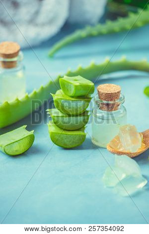 Aloe Vera Extract In A Small Bottle And Pieces On The Table. Selective Focus.